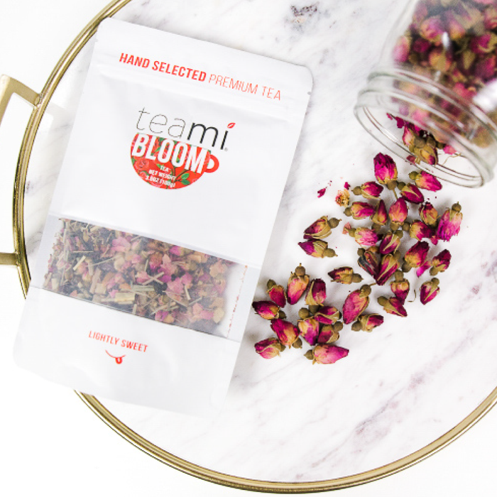 Teami Blends Bloom Tea spilling out of a jar