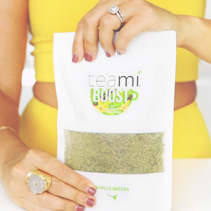 Woman Holding a bag of Teami Blends Boost Tea